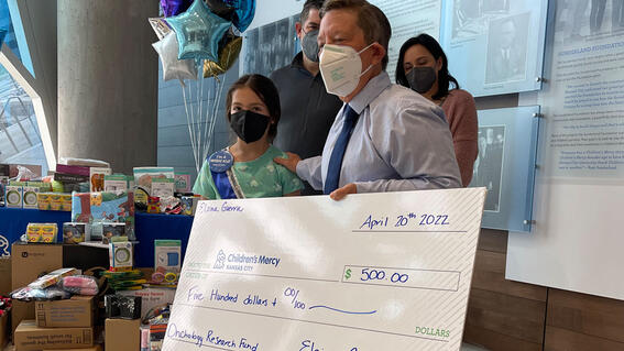 Elaina presents check to hospital