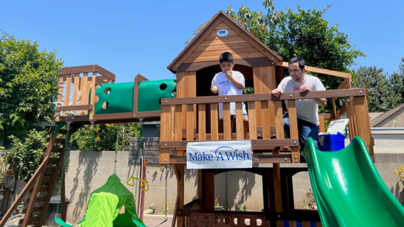 Ej dropping water balloons from his play structure