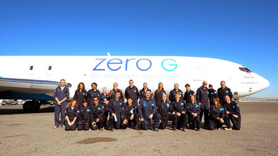 Kacey group photo outside of plane