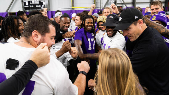 Sylvia joins in the Minnesota Viking's huddle.