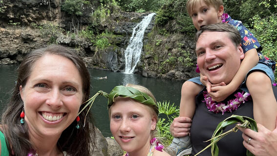 Nora and her family visiting a waterfall in Hawaii