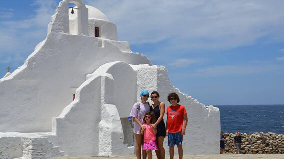 Elizabeth and family in front of white house in greece