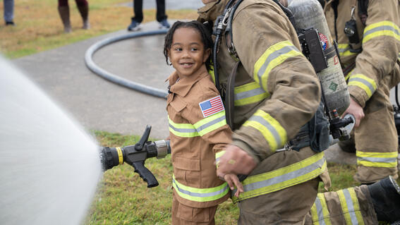 Jayce spraying water out of fire hose