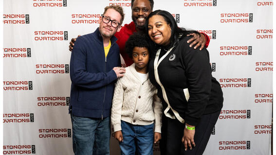 Austin is smiling with Macauley and his parents