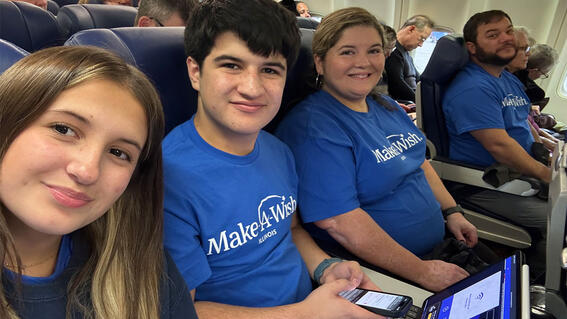 Vincent and family on plane wearing Make-A-Wish t-shirts