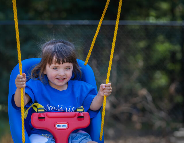 A young girl swinging on her new swing