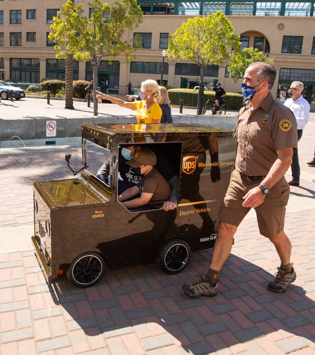 Mateo in his UPS Truck with UPS Driver Dave and Chapter President and CEO Jennifer Stolo in tow