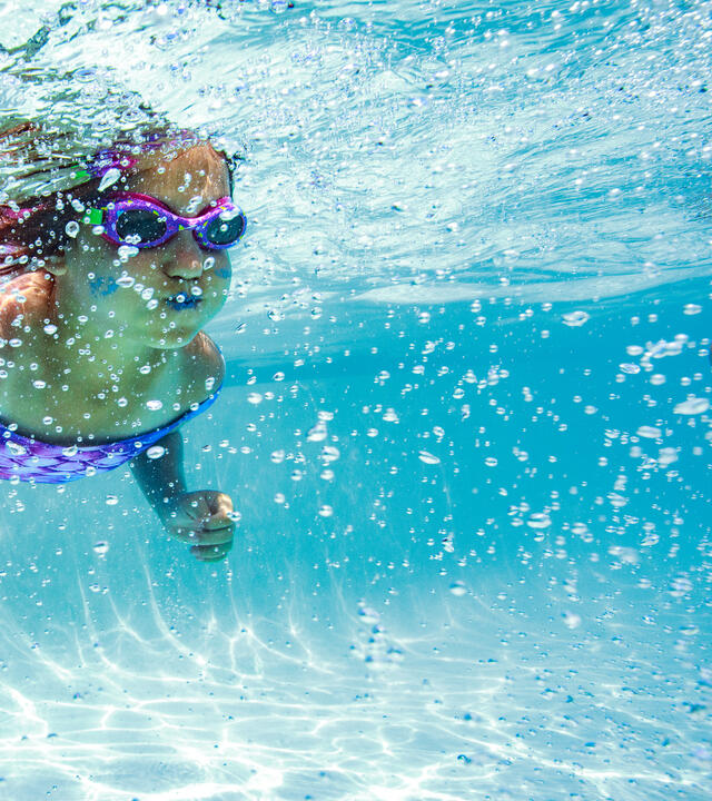 Wish kid Maggie swimming underwater