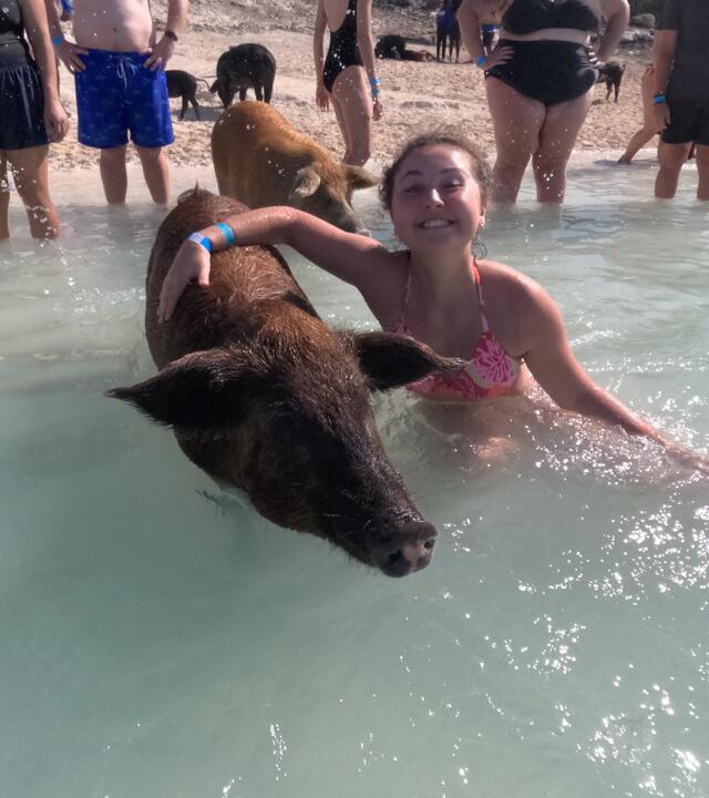 Addison swimming with pigs