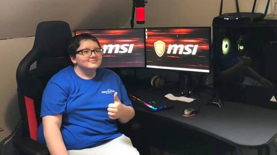Eli sitting at his gaming system 