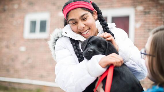 Sonia with a blacklab puppy 