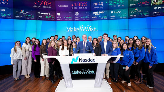 Make-A-Wish representatives stand at Nasdaq desk after bell ringing ceremony