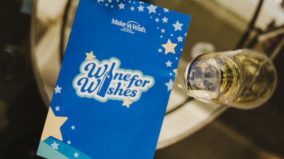 Wine for Wishes program on glass table 