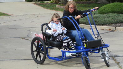 Emili and her mother on her bike