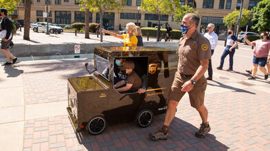Mateo in his UPS Truck with UPS Driver Dave and Chapter President and CEO Jennifer Stolo in tow