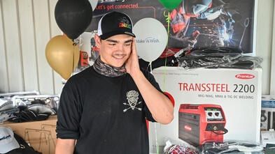 Noah looks in awe at all his new welding tools.