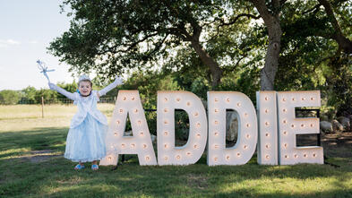 Princess Addie in front of a big sign of her name.