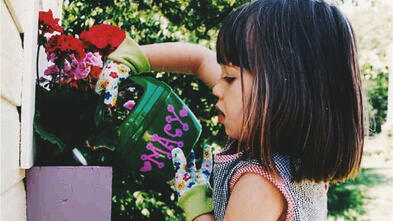 Macy Then watering flowers