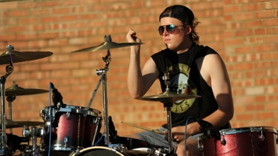 wish kid jack playing the drums outside 