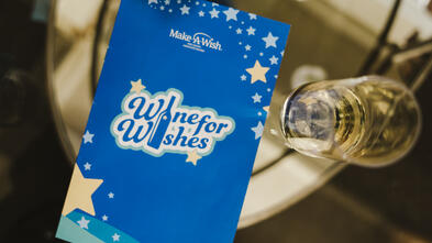 Wine for Wishes program on glass table 