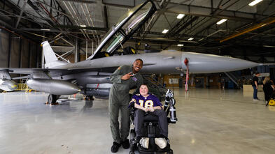 Nash and Justin Jefferson in front of a fighter jet