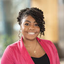 Young black woman with pink jacket over black top