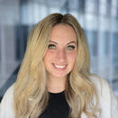 woman with long blond hair, white jacket and black top