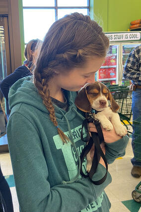 Hannah cuddles her new furry friend, Oscar.