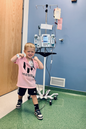Knox at the hospital getting a blood transfusion while flexing his arms