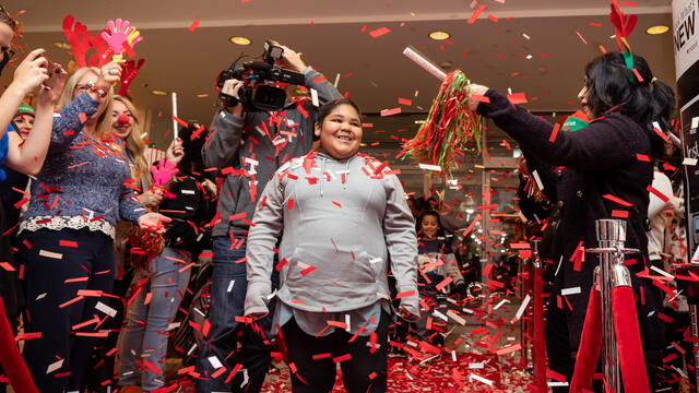 Glenda smiles as confetti falls at Macy's