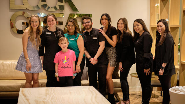 Holly and Kayla pose for a photo with the spa team.