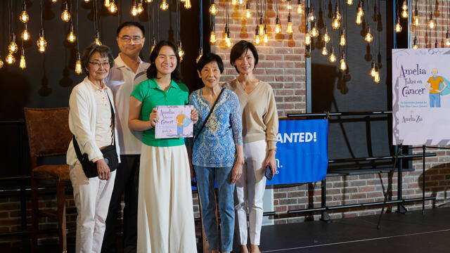 Amelia and her family on stage at her book launch party