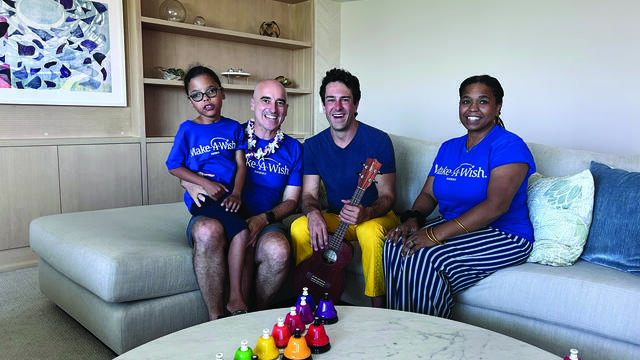 Atticus and his parents taking a picture with Mr. Rob
